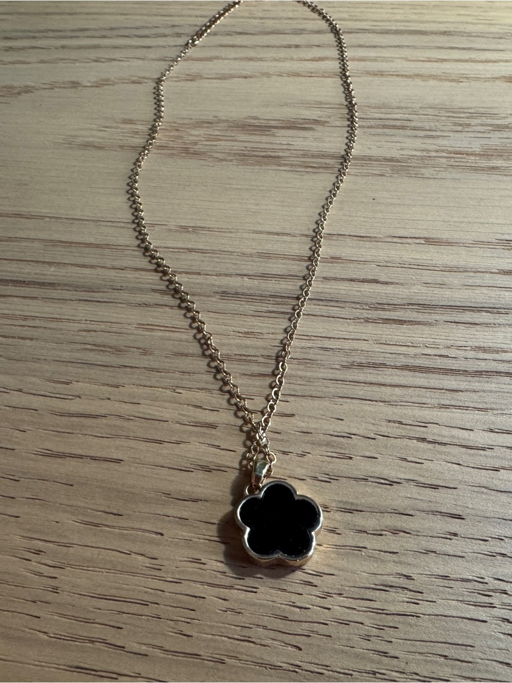 Sleek Black and Gold Clover Necklace.